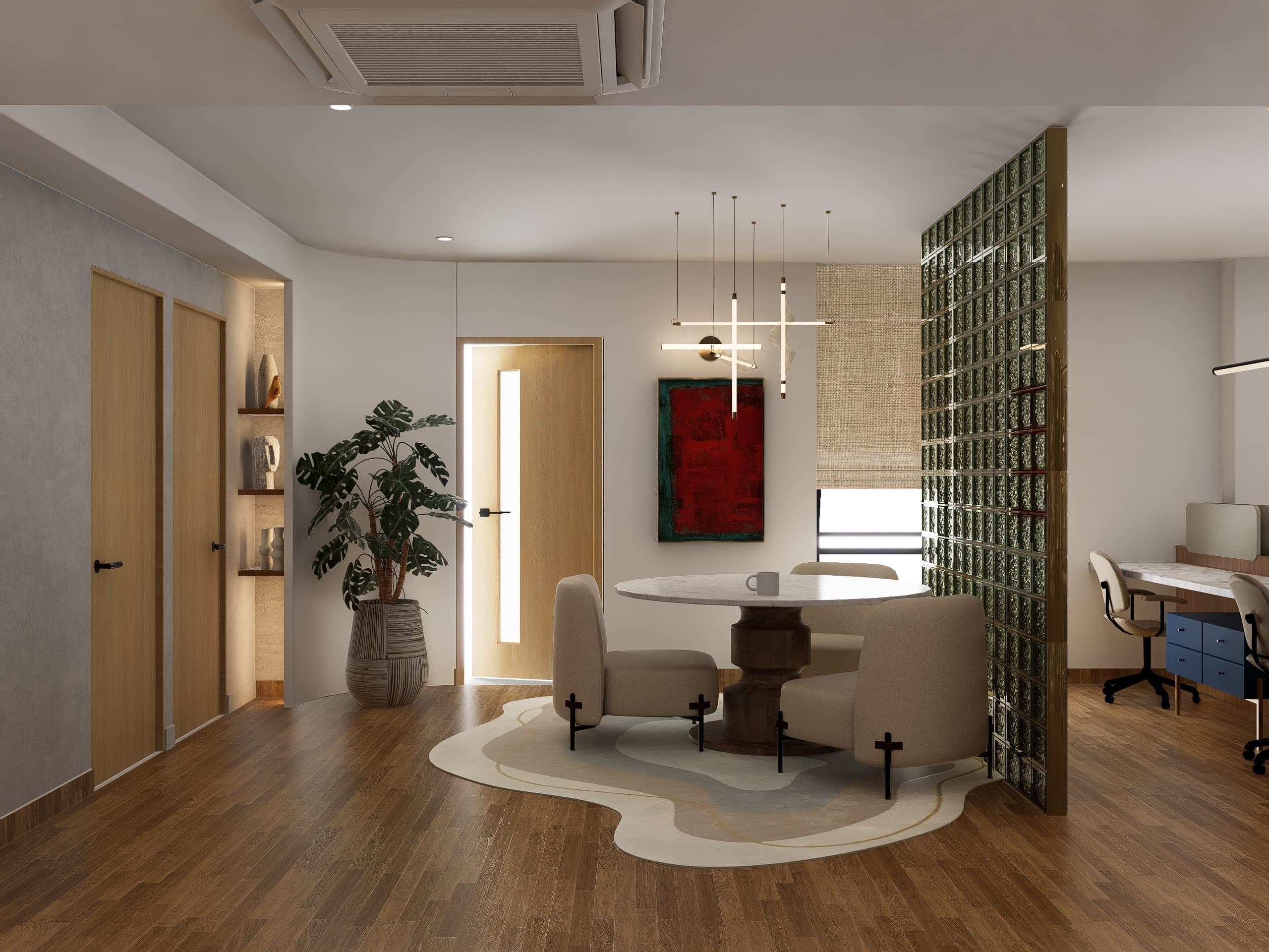 An informal meeting table occupies the threshold between the open floor and the glass-block partition, defined by an organic rug and a vivid red artwork above. It is the only moment of strong colour in the scheme, marking the zone as distinct within the sequence.