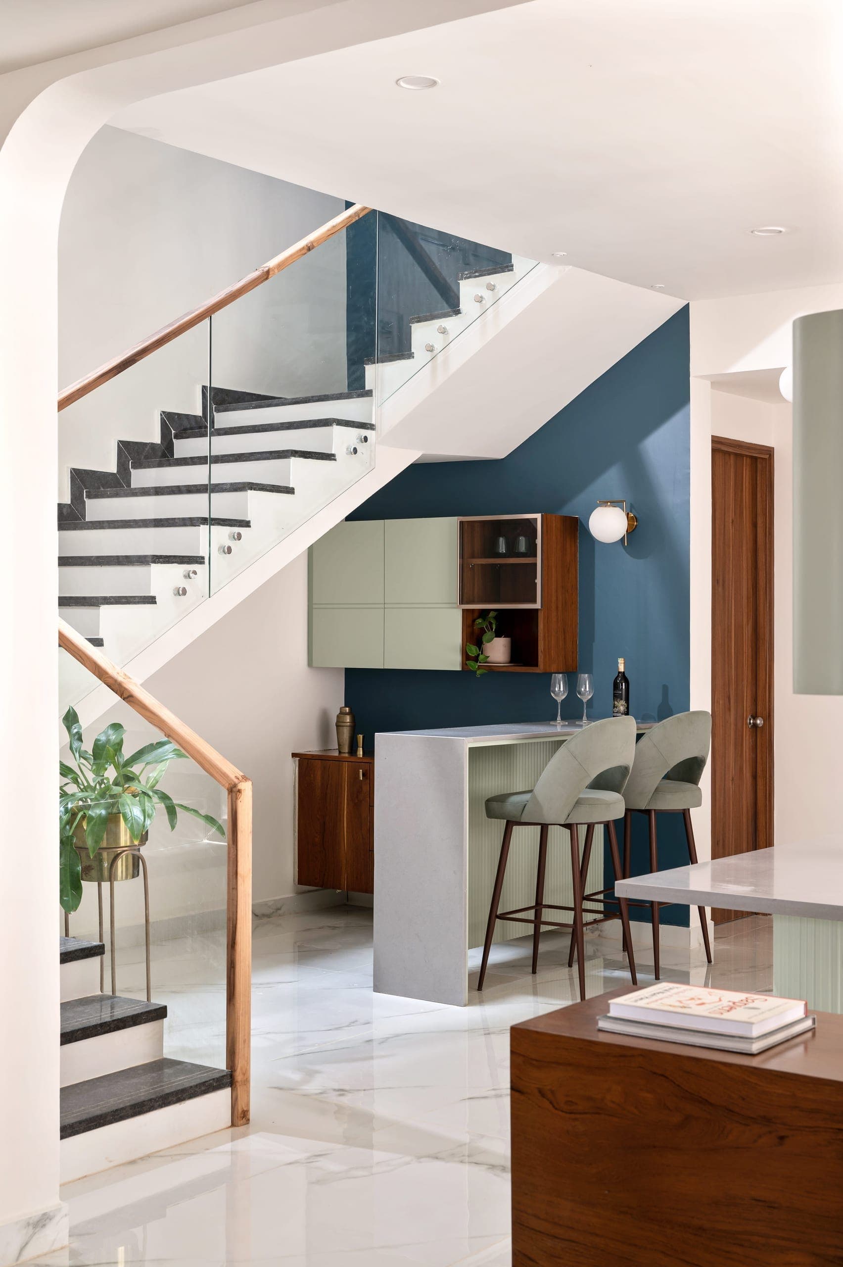 Tucked beneath the staircase, the bar area makes efficient use of space while maintaining the home's overall language. Compact yet well-defined, it blends function with a sense of quiet detail, turning an otherwise residual corner into a purposeful feature.